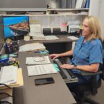 Image of Carolyn Greeno, District 1 assistant, working at her computer
