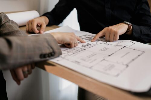 Generic business people looking at blueprints