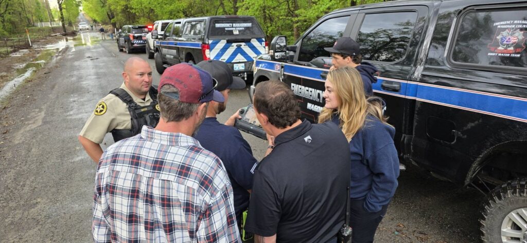 Commissioner James Hanning conferring with emergency management officials